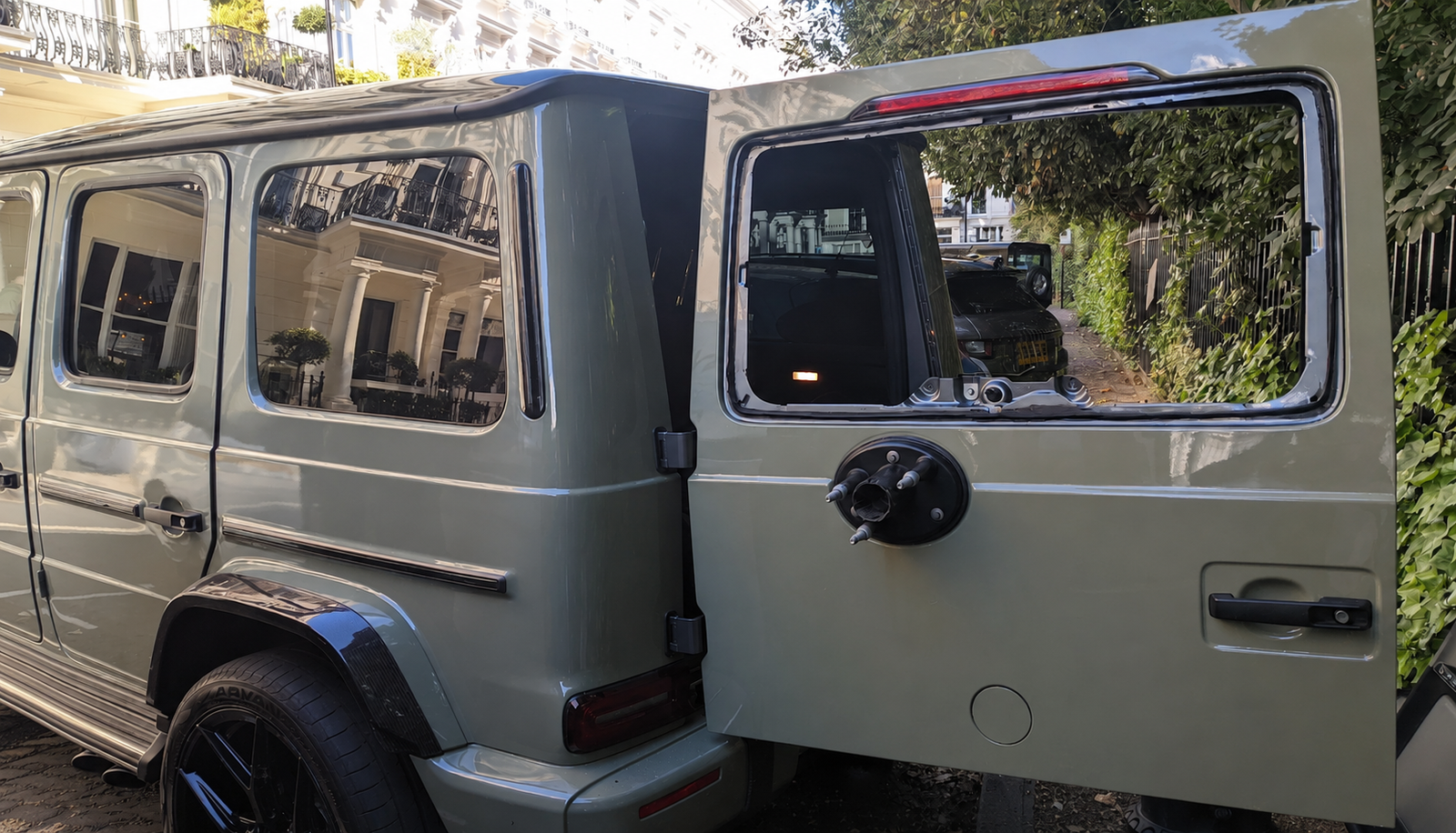 Rear glass replacement on a Mercedes G-Wagon with boot door open showing removed rear window